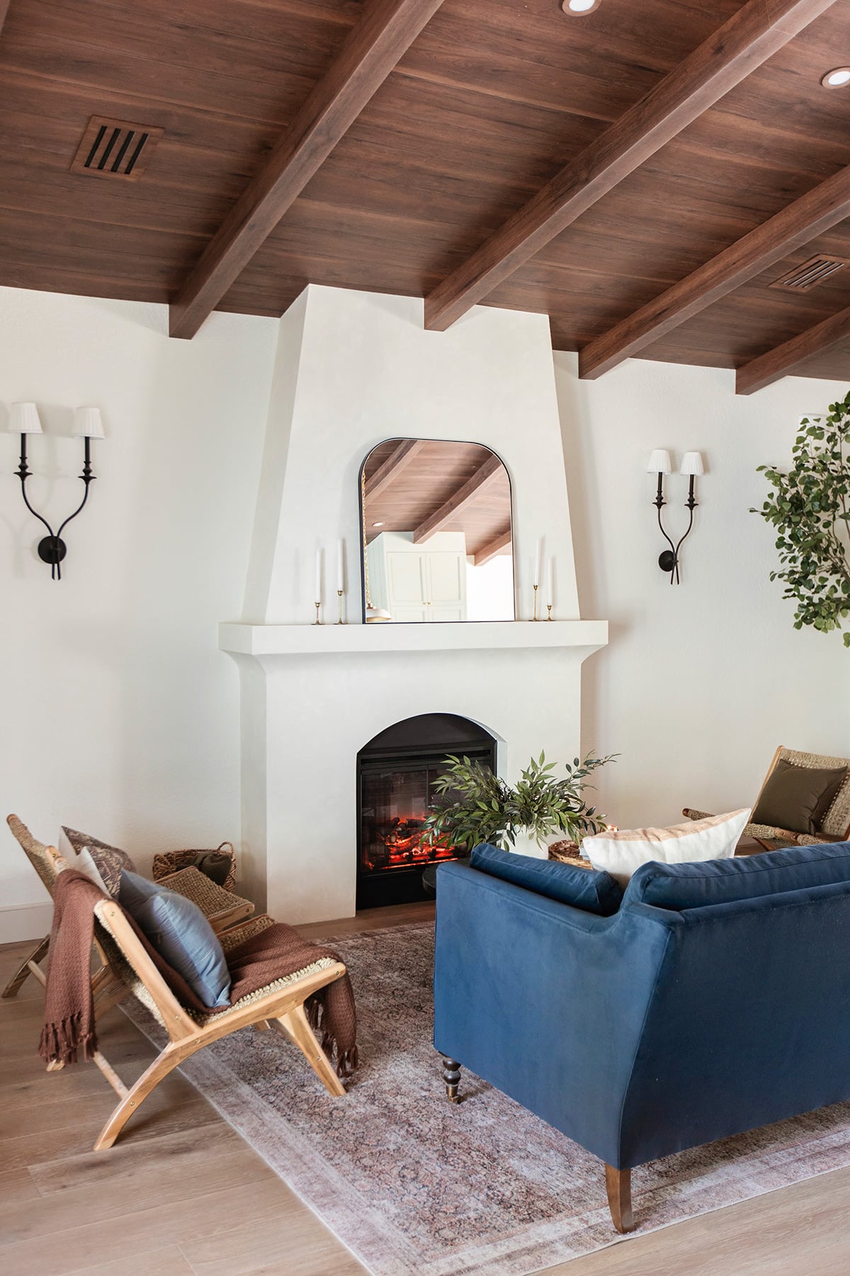 spanish style living room with diy electric fireplace, wood beam ceiling and sw alabaster walls
