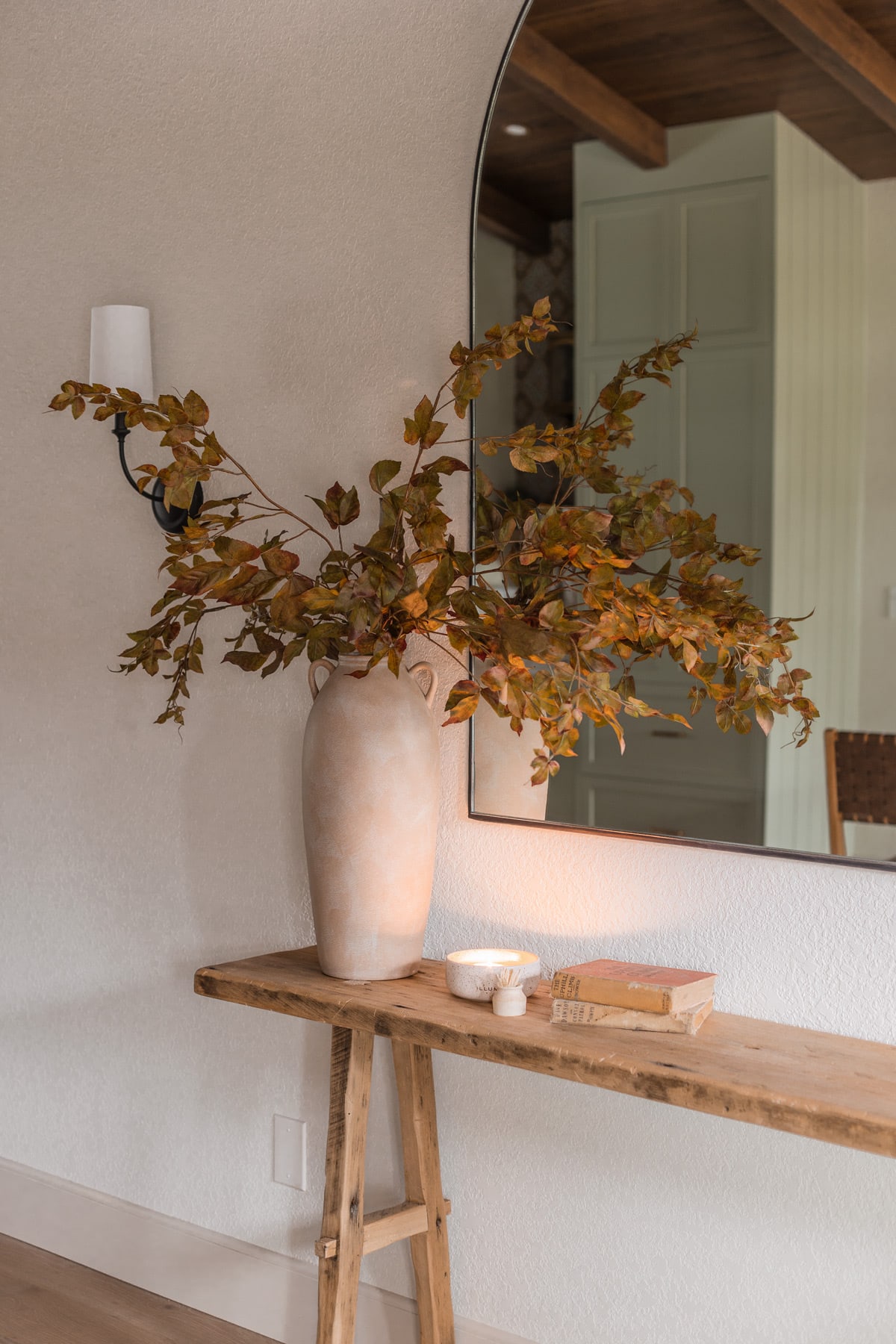 faux fall branches in vase on console table