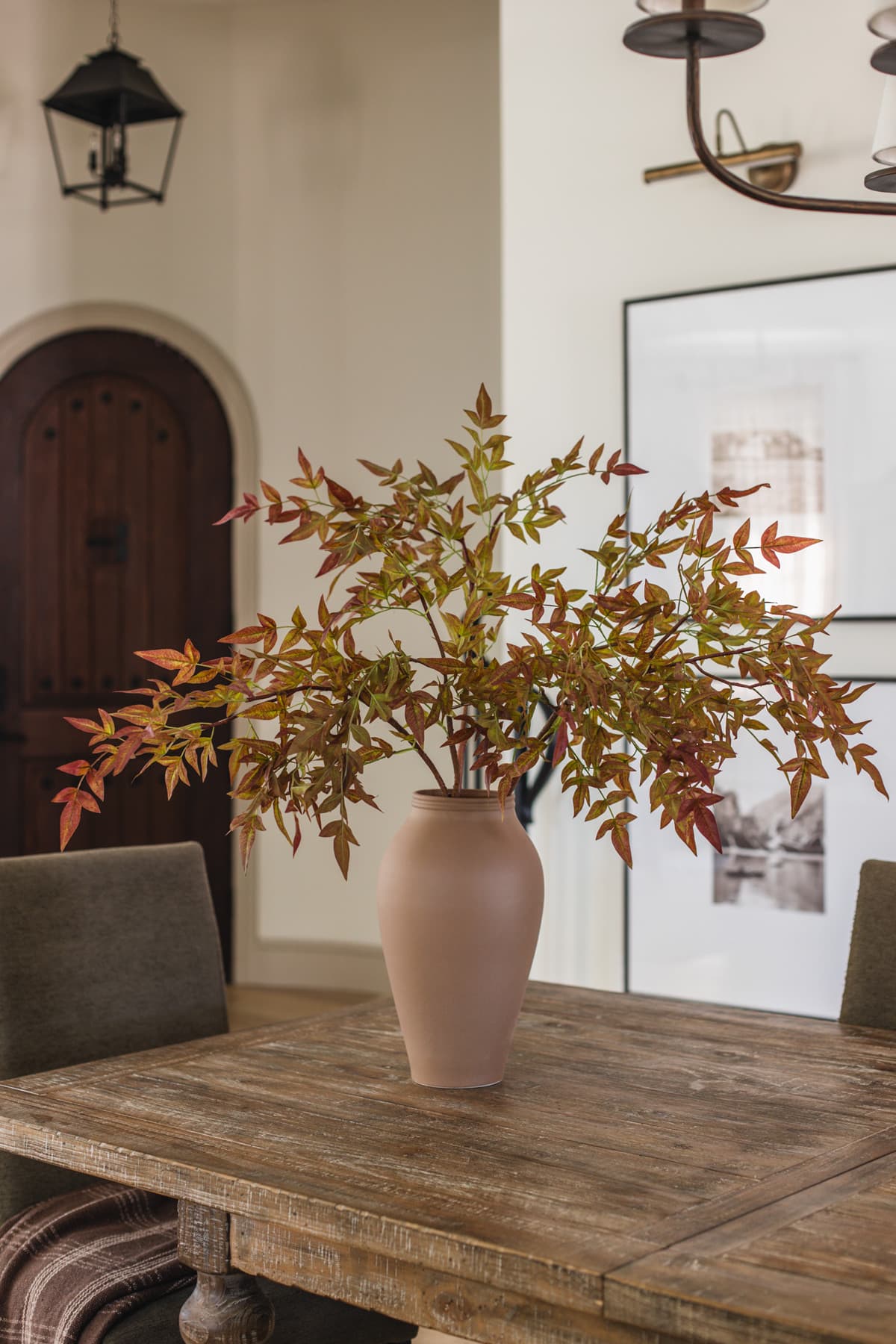 faux nandia fall branches in vase on dining table