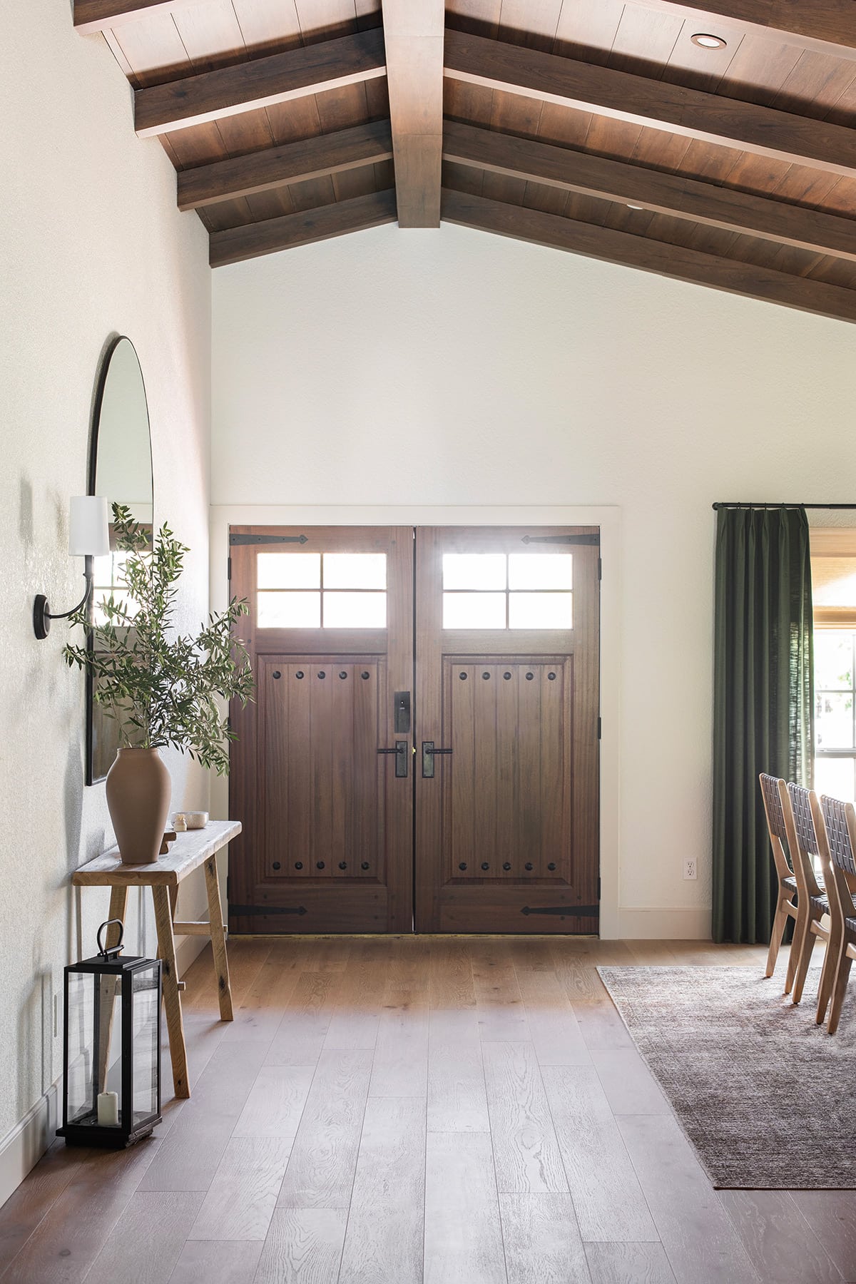 mediterranean style foyer with rustic wood doors and beam ceilings