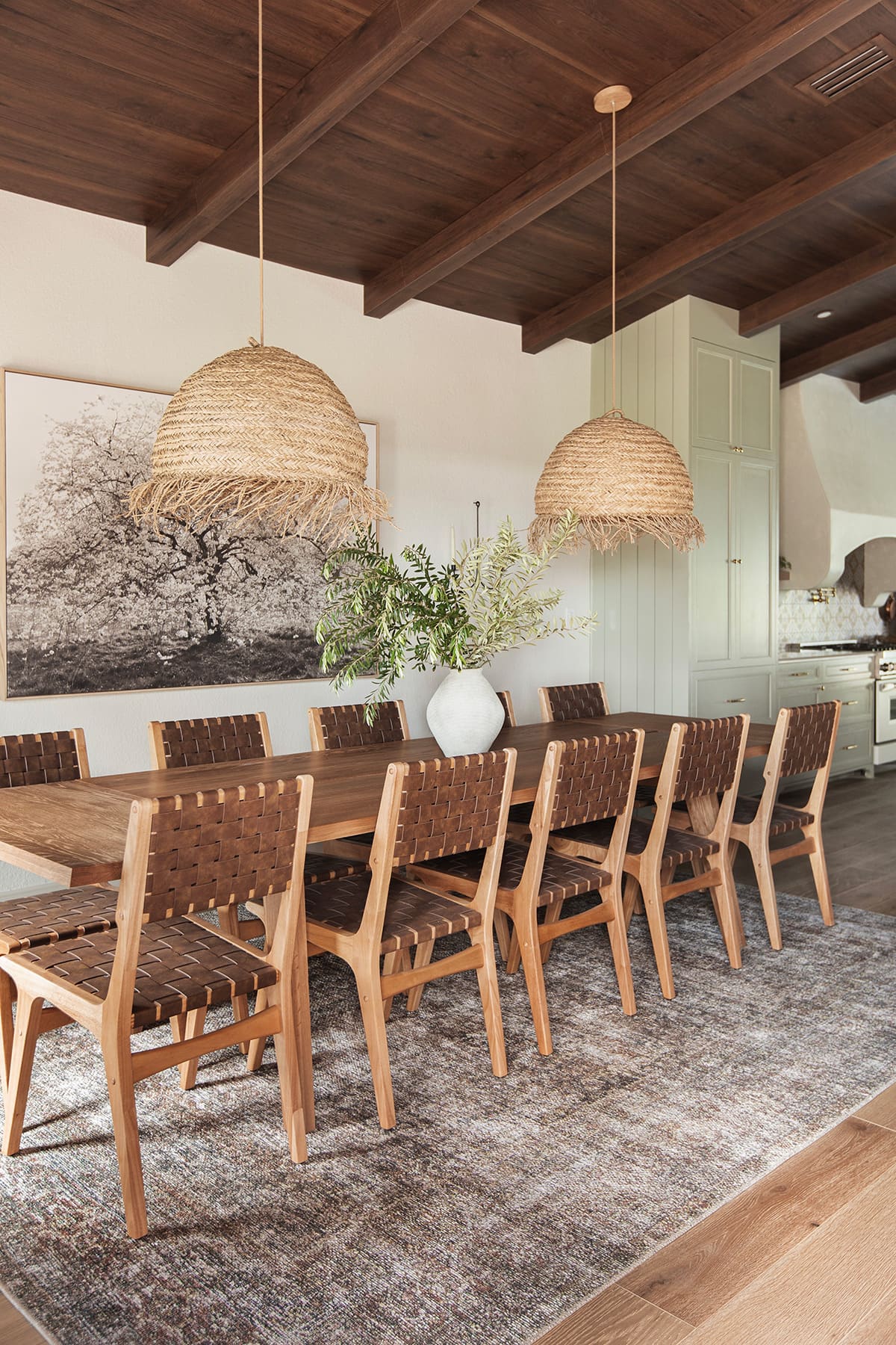 mediterranean style dining room with wood and leather chairs, seagrass pendant lights