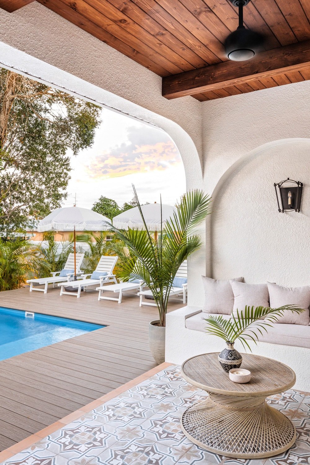 mediterranean outdoor space with patterned tile and wood beam ceiling