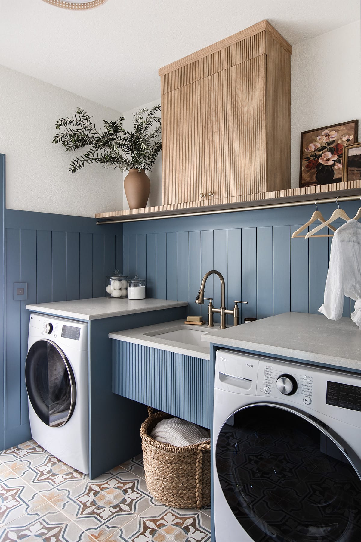 laundry room with sherwin williams blustery sky walls, quartz countertops, pole wrap shelf and hanging rod