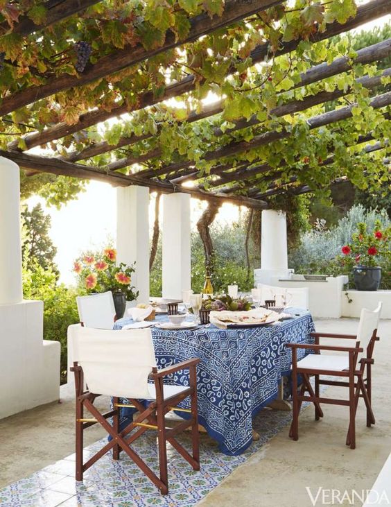 outdoor dining under wood pergola with vines
