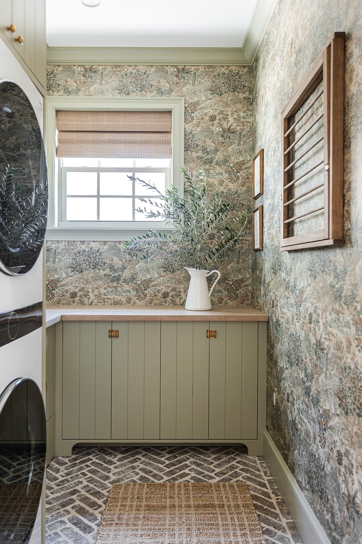 laundry room with toile wallpaper and diy svelte sage green cabinets