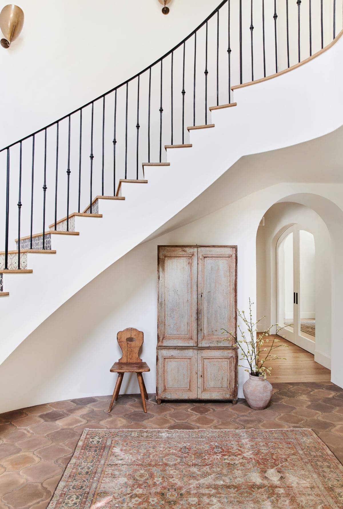 spanish style foyer with curved iron  railing staircase