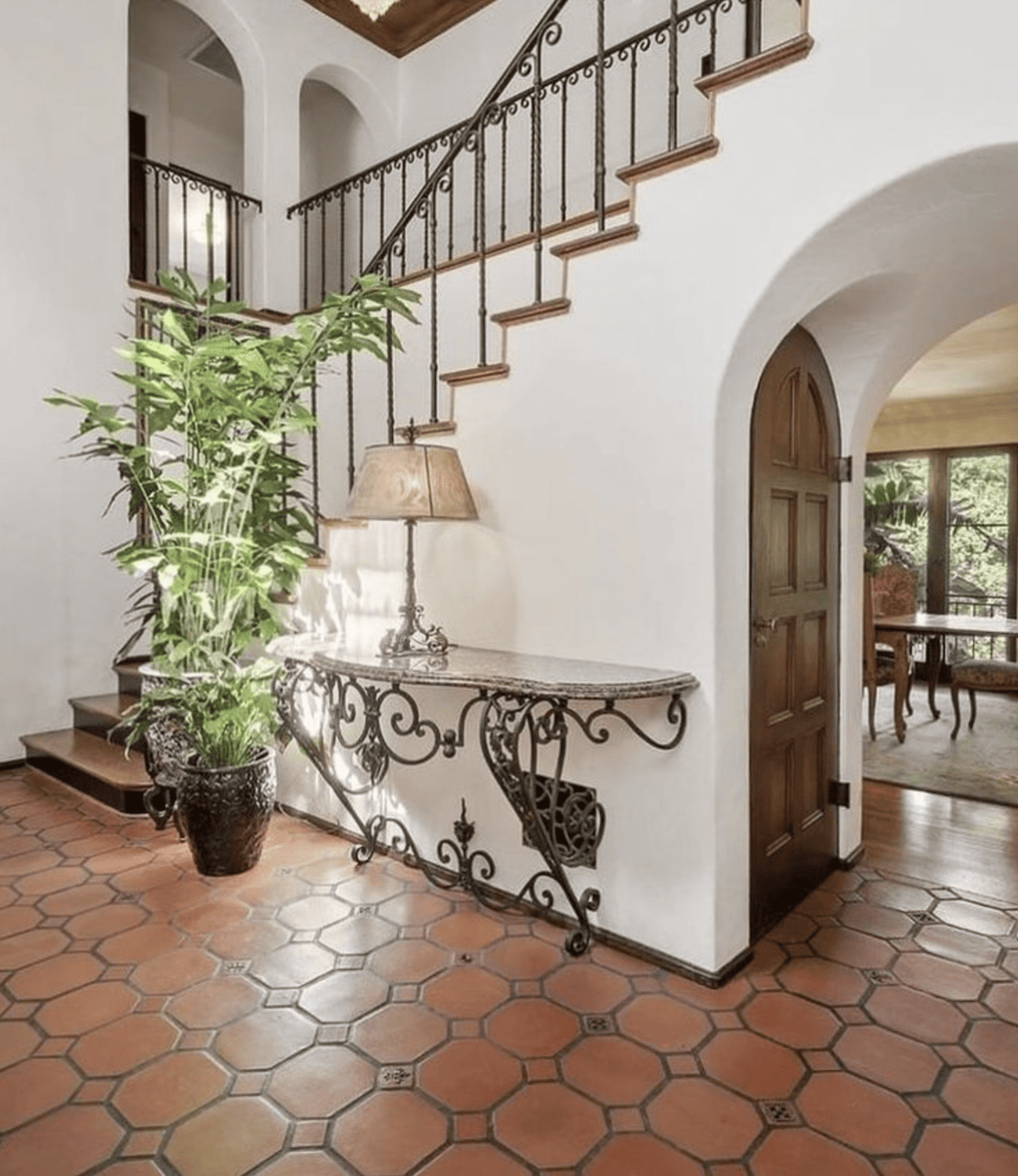 spanish style foyer with terracotta tile and wrought iron