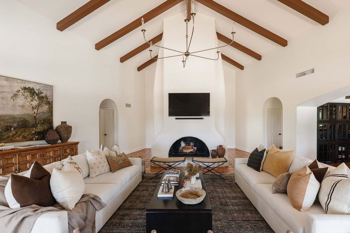 modern spanish style living room with white walls and wood beams