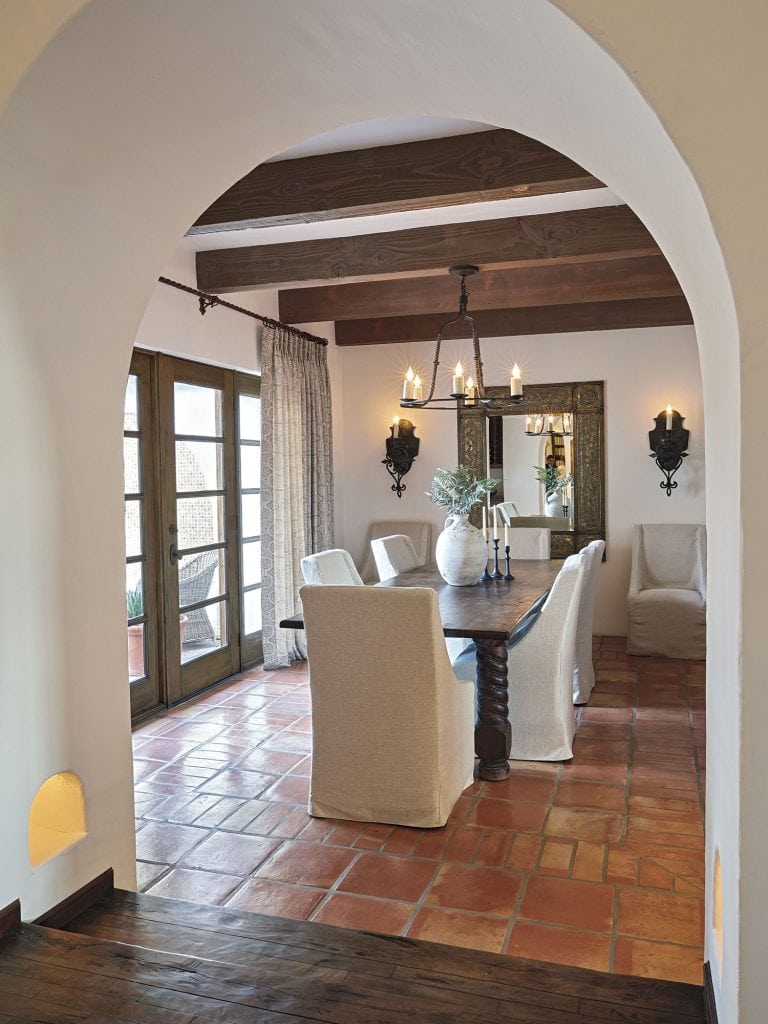spanish style dining room with terracotta tile floors