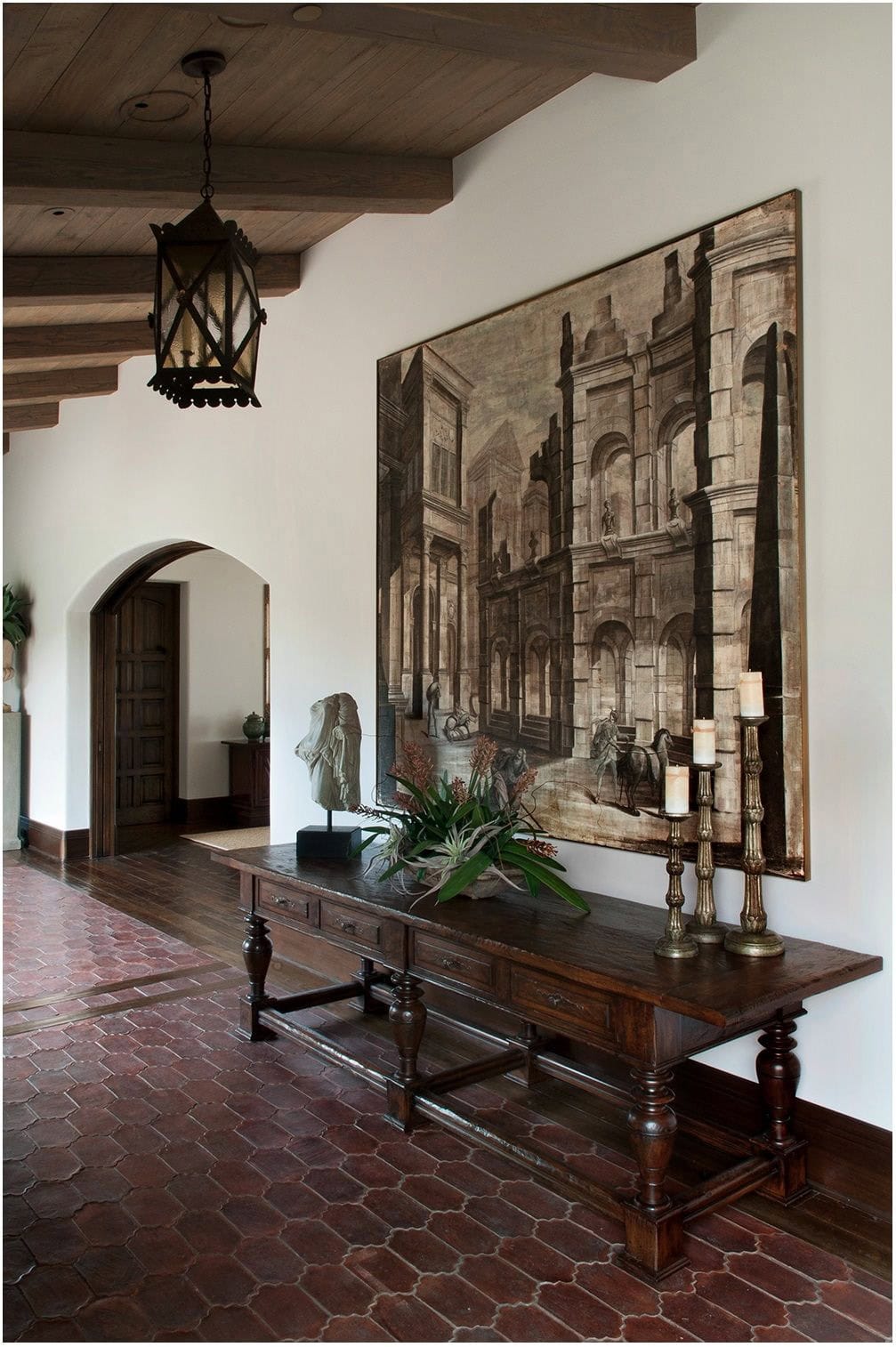 spanish style hallway with terracotta tile and dark wood
