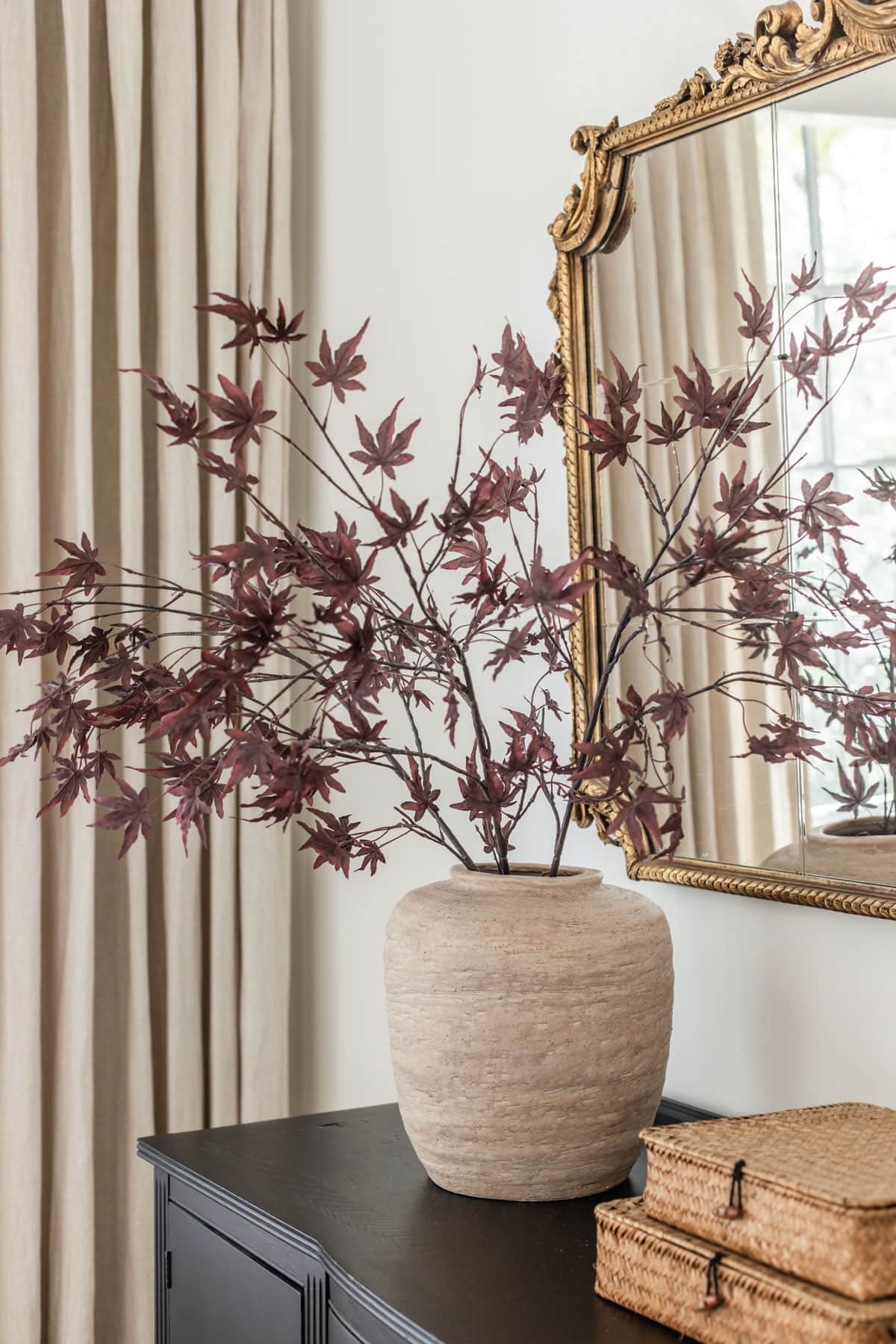 dark red japanese maple leaf branches in a vase for fall