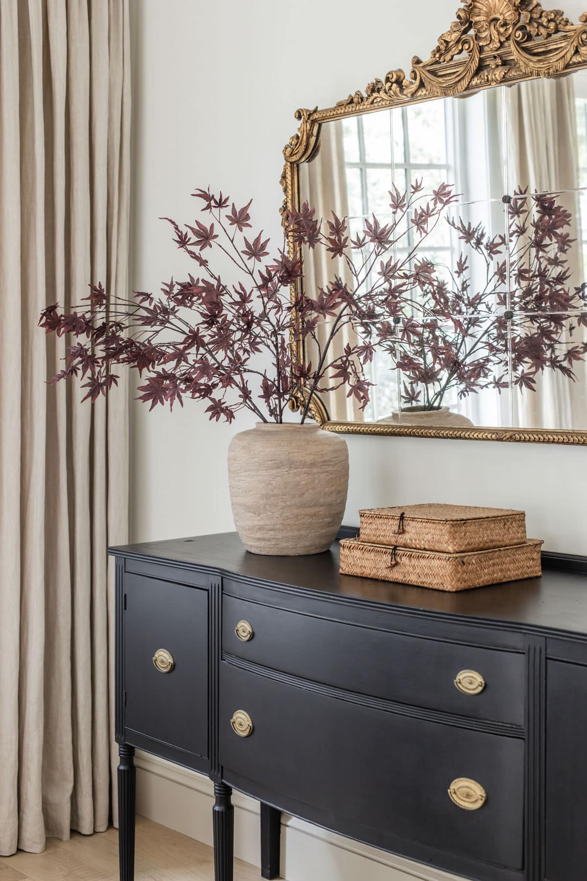 dark red maple leaf branches styled in a vase for fall