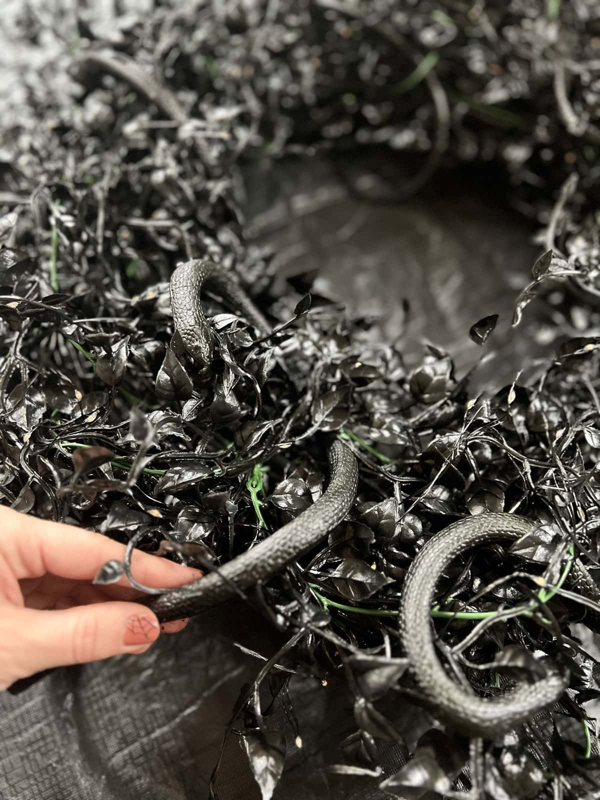 black halloween wreath with snakes