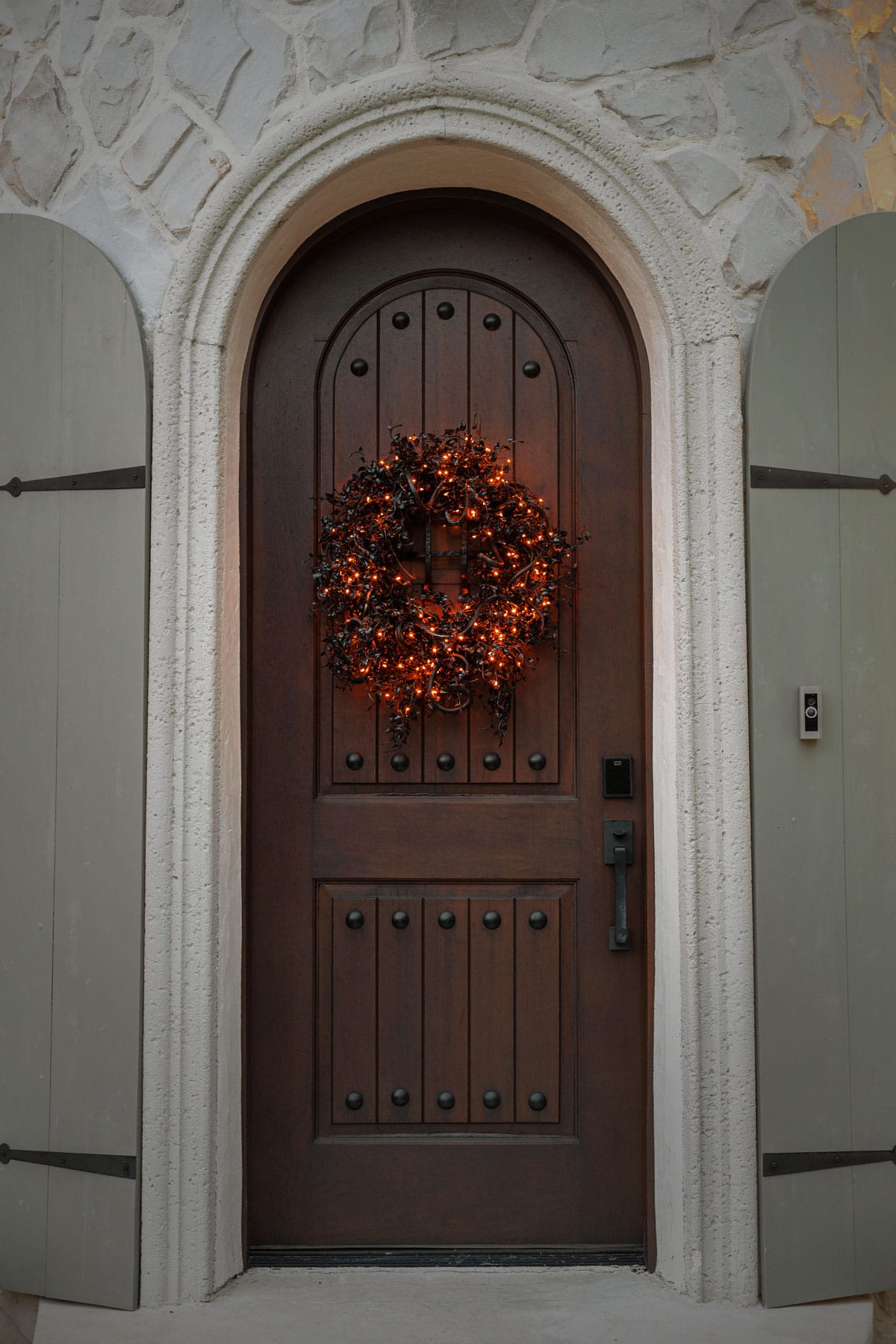 halloween wreath with black ivy and snakes on front door