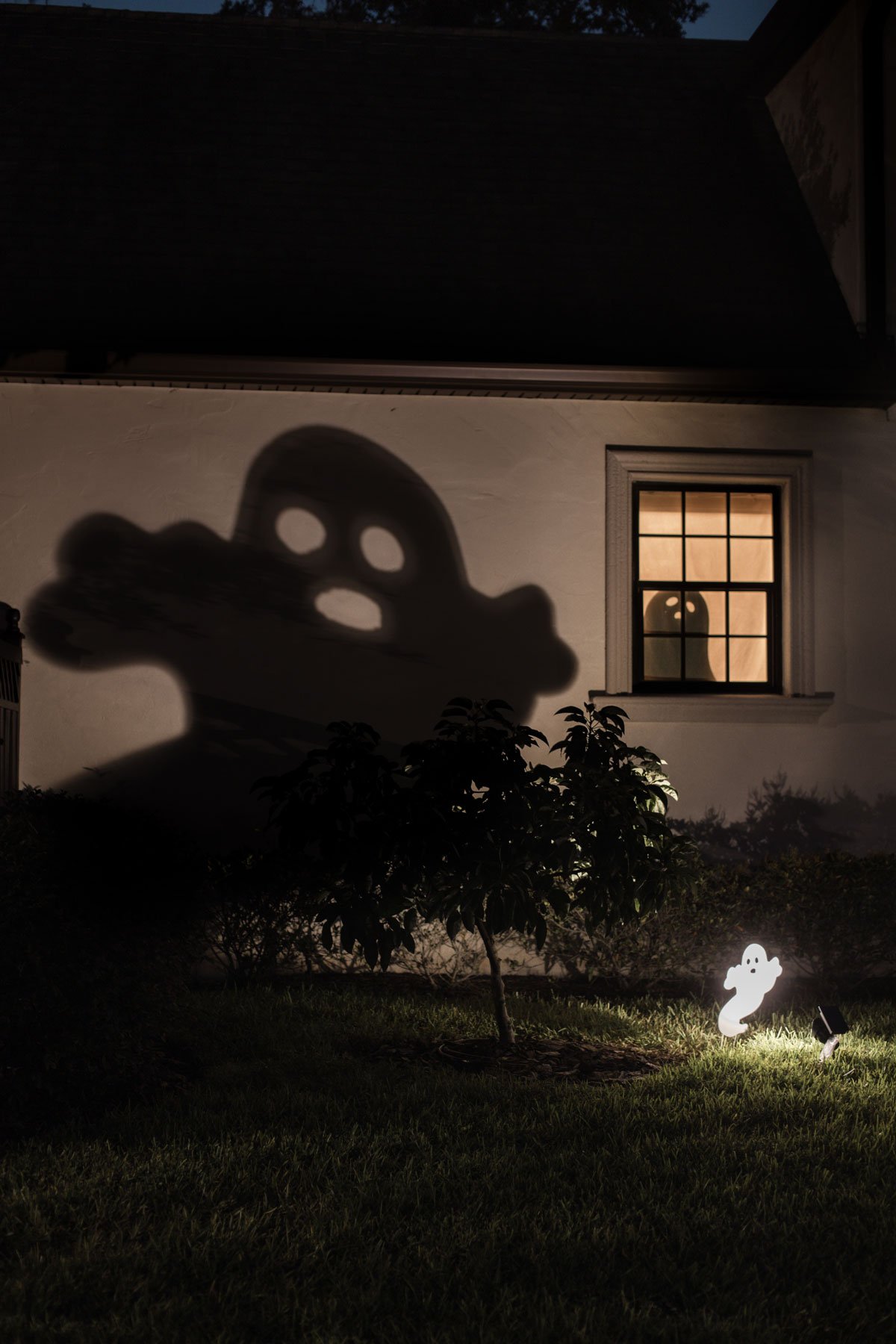 halloween ghost shadows projected on house