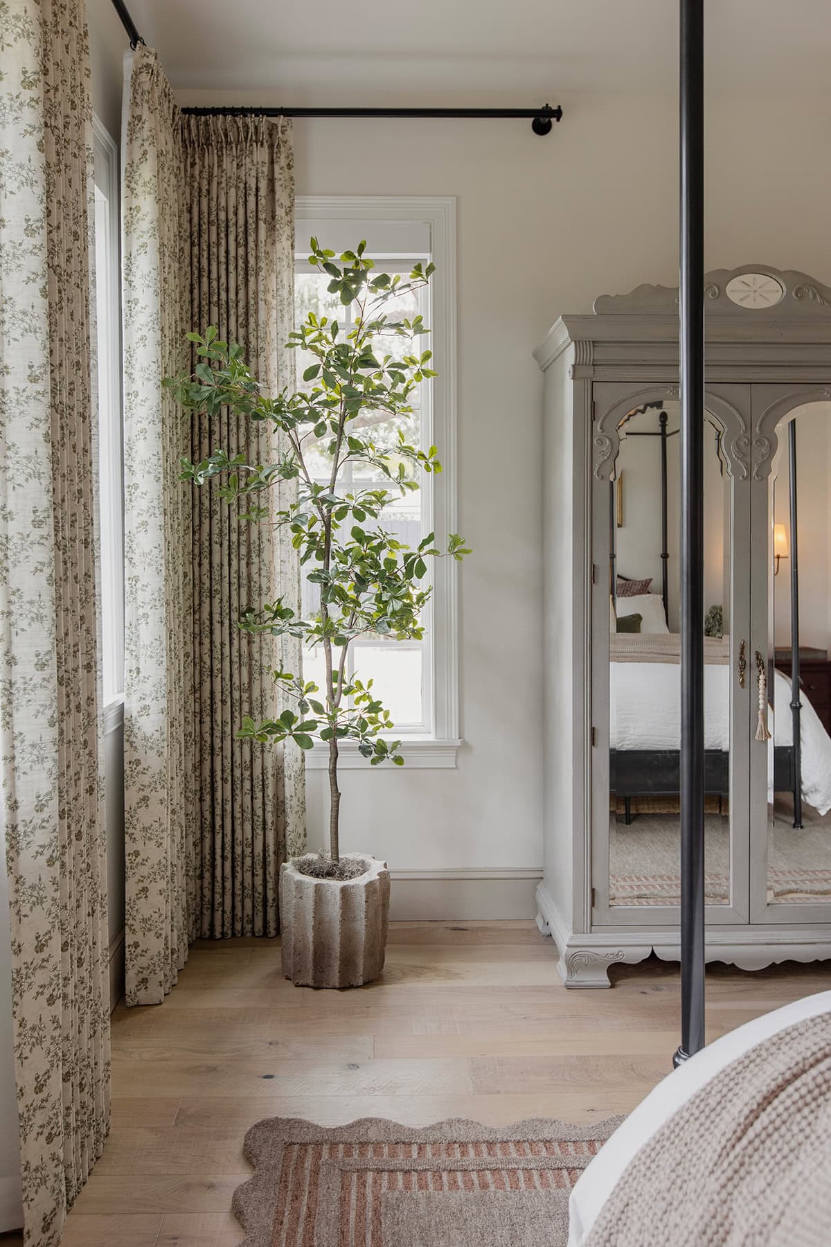 master bedroom with loloi scottie rug, twopages sarale curtains, faux black olive tree