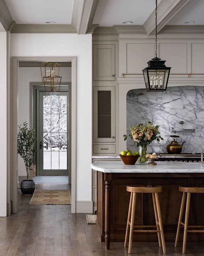 traditional kitchen with marble backsplash and dark wood island