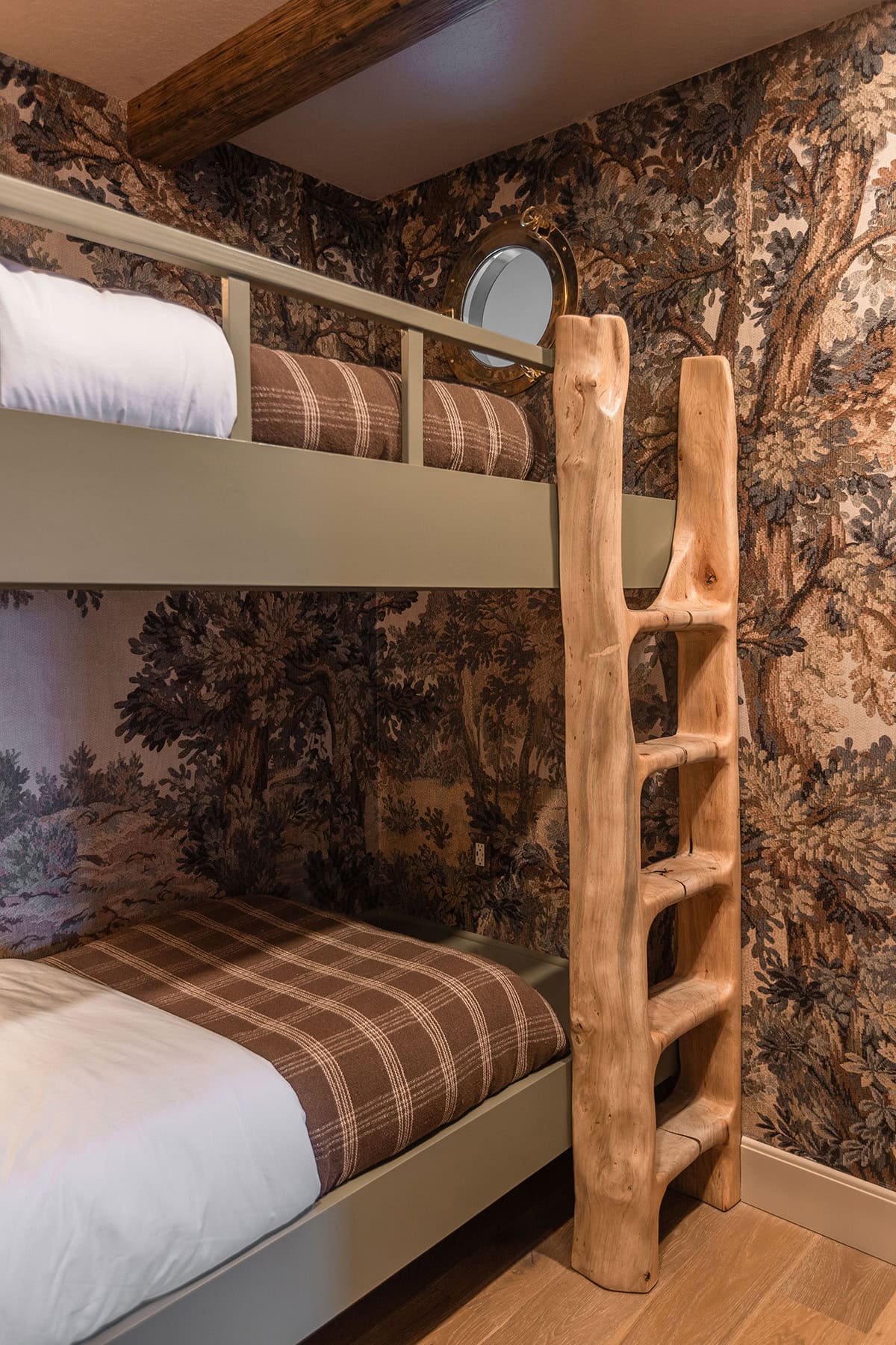 forest themed bedroom with bunk beds and tree mural