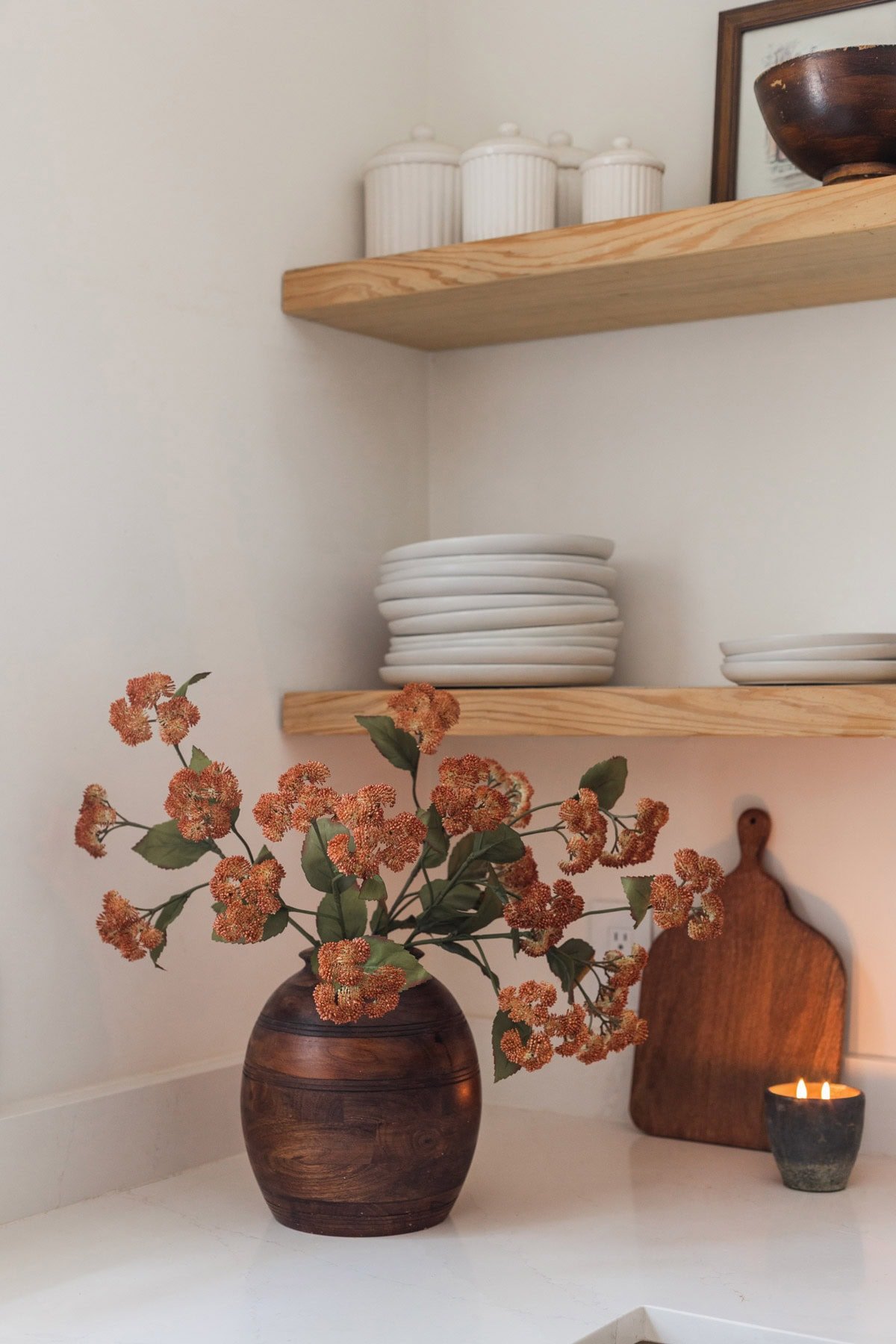 target fall orange sedum stems in wood vase in kitchen