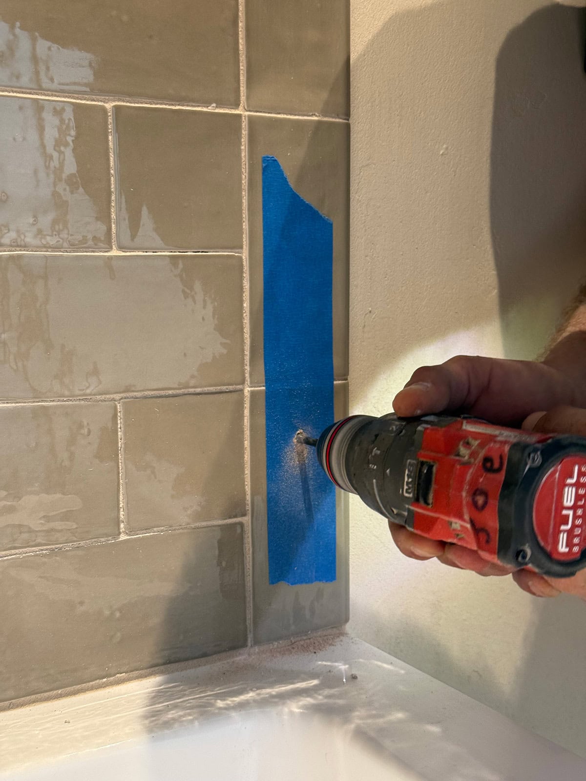 installing a shower screen on a tub