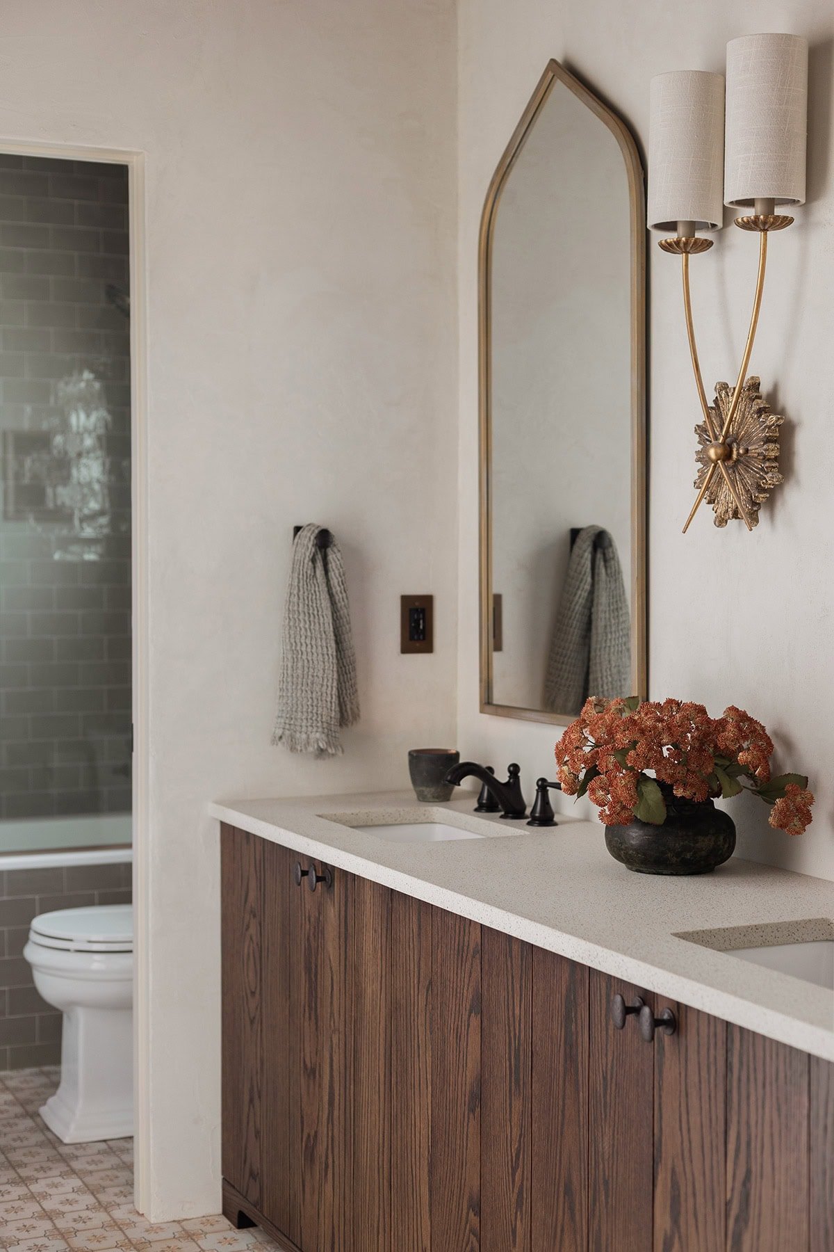 spanish inspired bathroom with dark oak vanity
