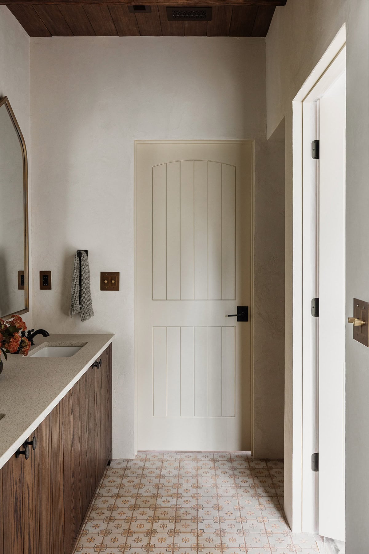 spanish inspired bathroom with dark oak vanity
