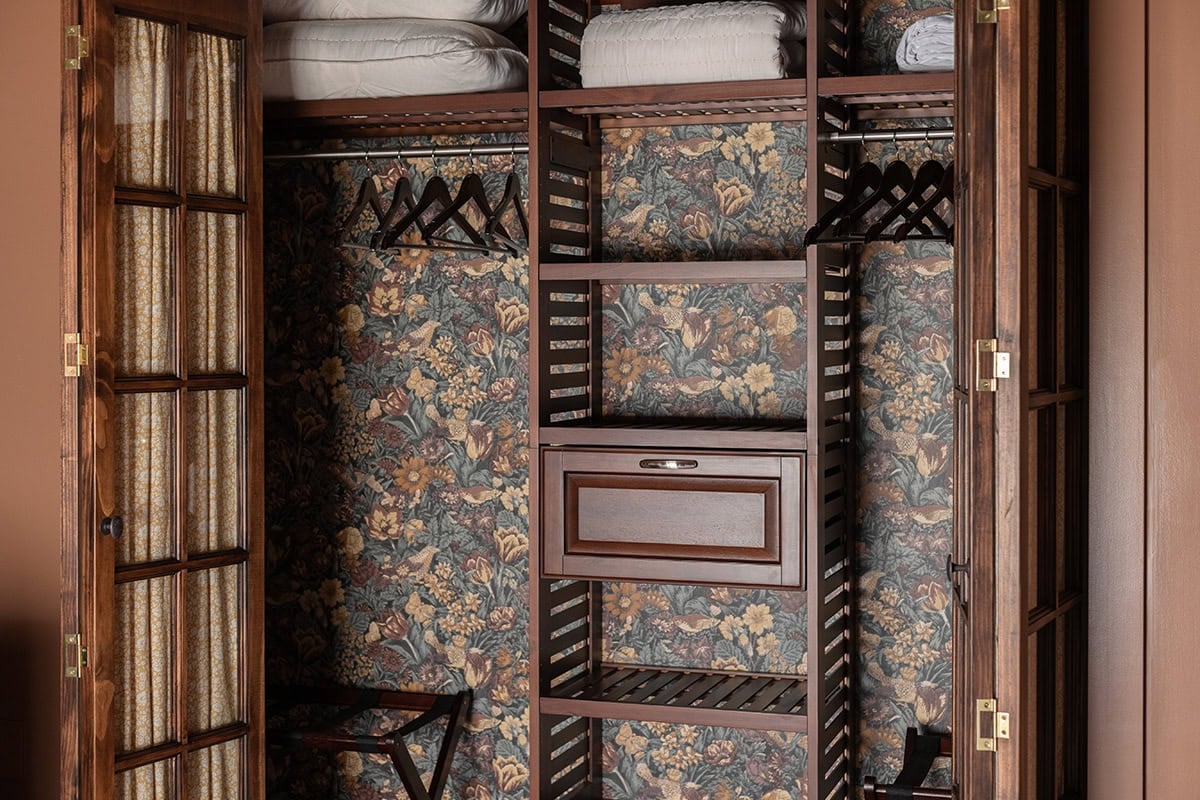 closet with floral wallpaper and french doors from lowes