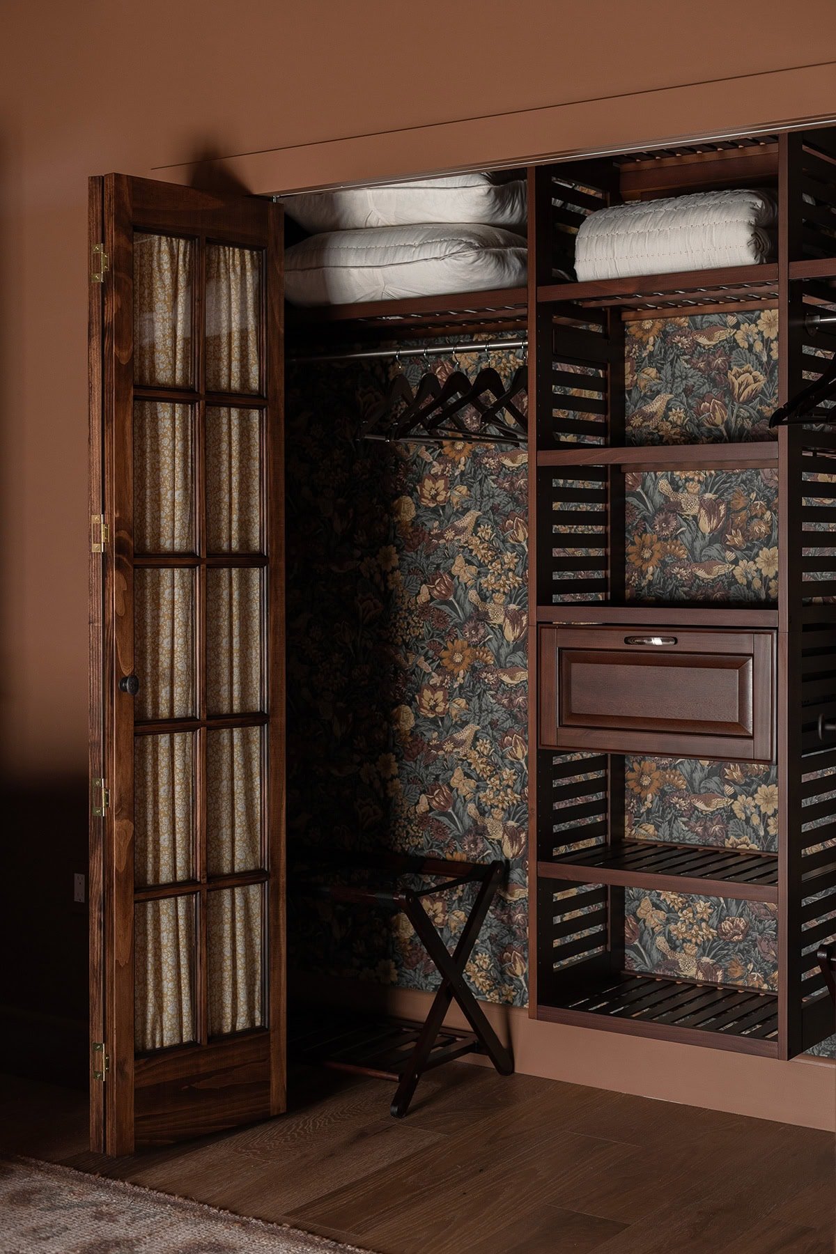 closet with floral wallpaper and french doors from lowes