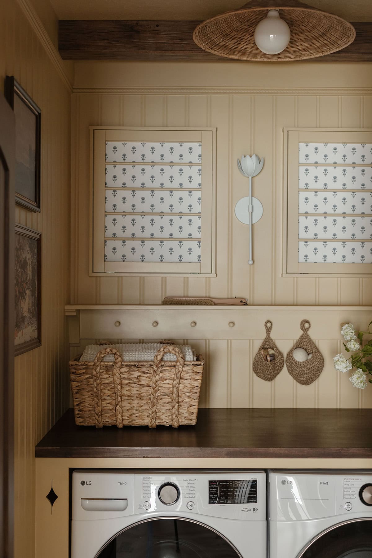 butter yellow laundry room with peg board rail shelf